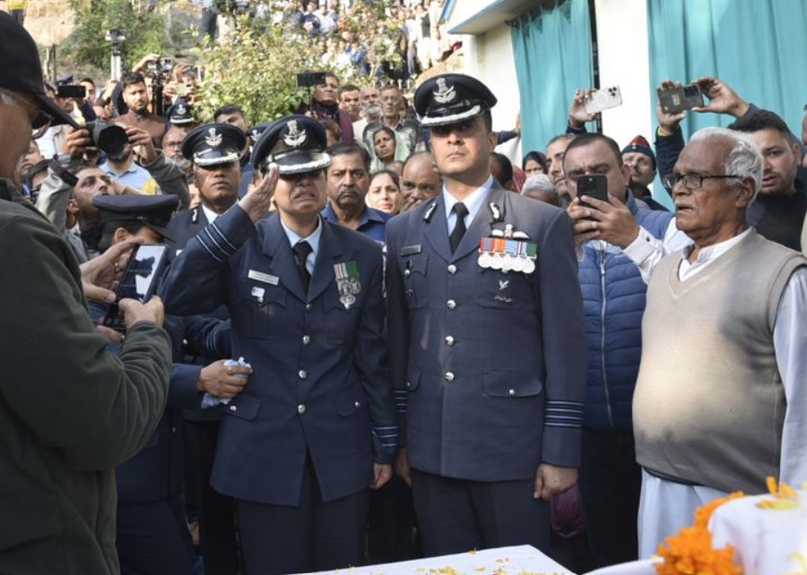 Afshan Akhter, wife of Wing Commander Namansh Syal, salutes his coffin while a giving him a tearful goodbye