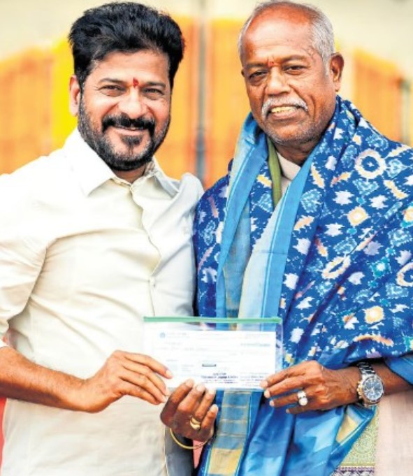 Ande Sri while receiving a cash award from Chief Minister Revanth Reddy on Telangana Formation Day