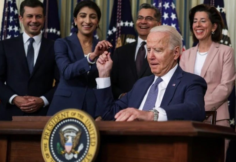 Lina Khan with Joe Biden during a press conference