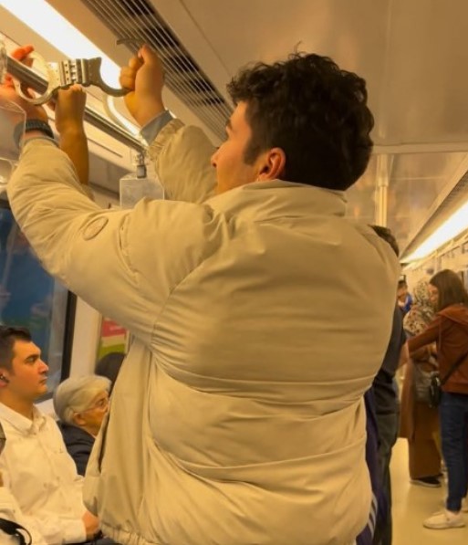 Emre Nalçakar while handcuffing a passenger