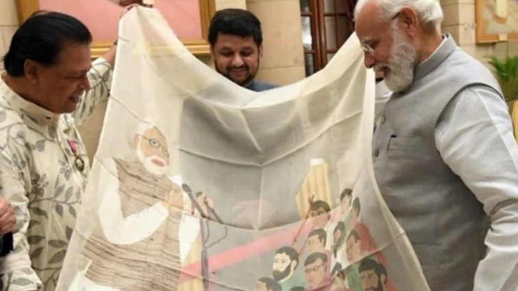 Biren Kumar Basak while gifting a shawl to Prime Minister Narendra Modi