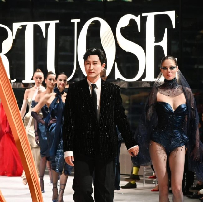 Cheney Chan during a ramp walk with models