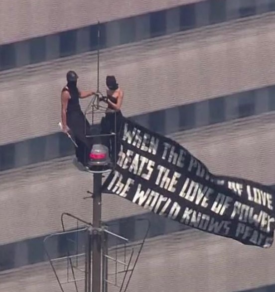 Angela Nikolau and Ivan Beerkus posing at the 1,454-foot antenna spire of the Empire State Building in New York City