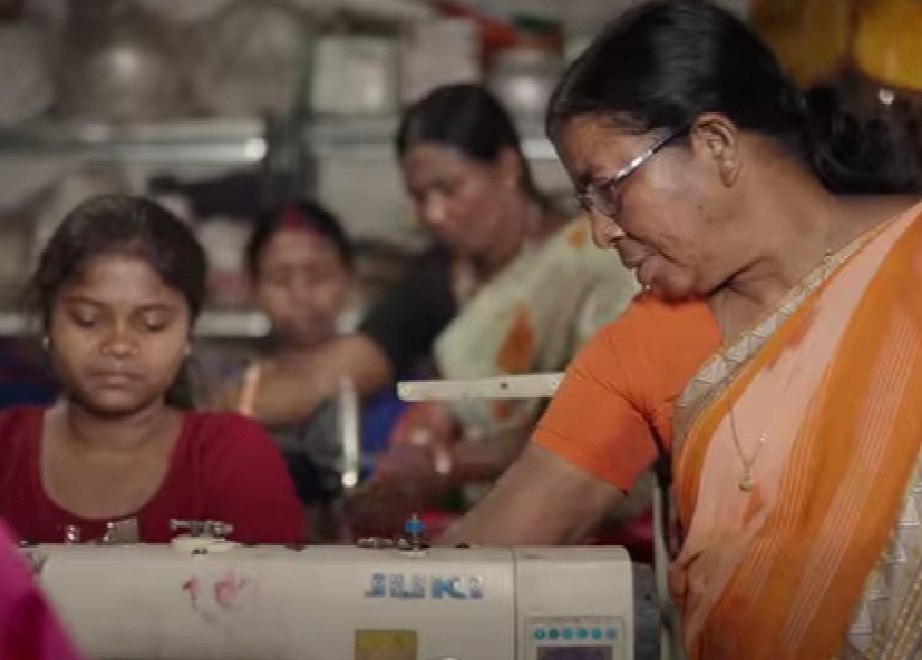 Budhri Tati while teaching stitching to young women