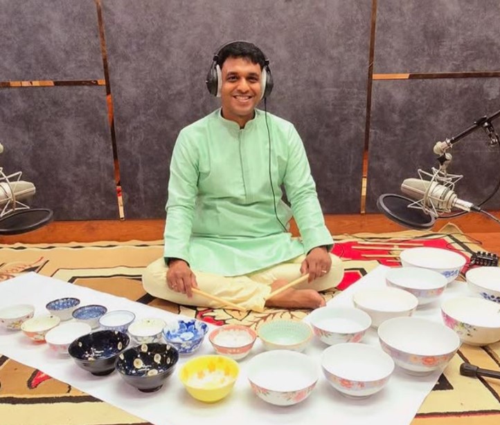 Vikash Achutaramaiah posing with porcelain water bowls