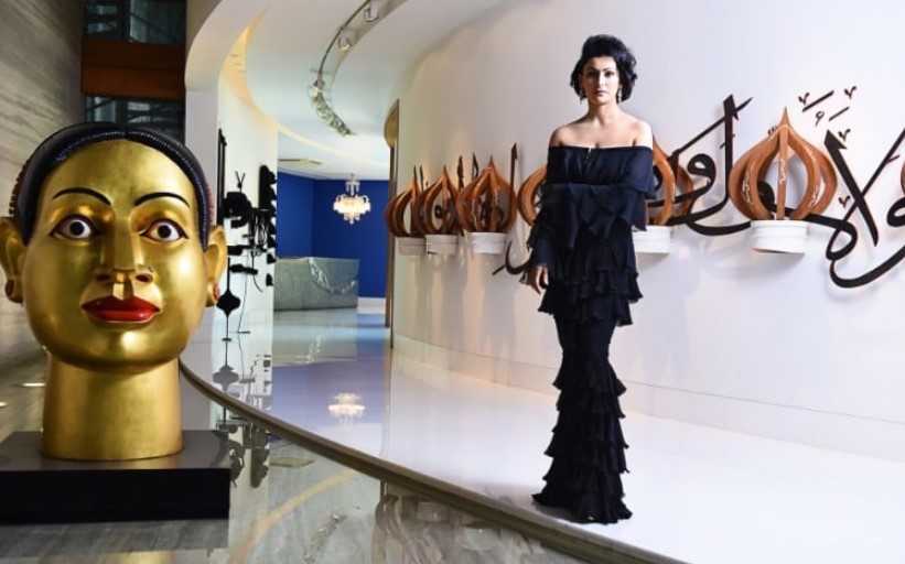 Shalini Passi posing with some of her art collections at her home